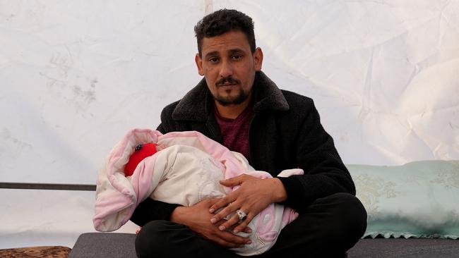 Khalil al-Suwadi holds his niece Afraa. Picture: AFP