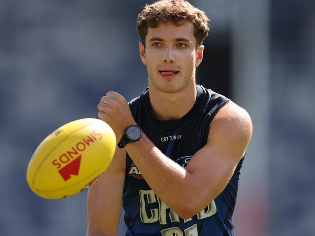 GEELONG, AUSTRALIA - MARCH 06: Oscar Murdoch of the Cats handballs during a Geelong Cats AFL training session at GMHBA Stadium on March 06, 2024 in Geelong, Australia. (Photo by Robert Cianflone/Getty Images via AFL Photos)