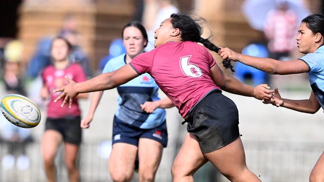 Queensland player Heidi Dennis trying to evade her rival.