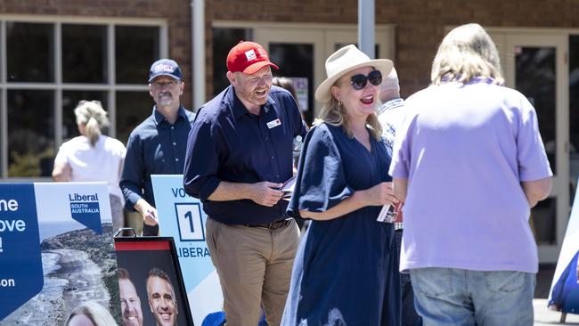 Labor Candidate Alex Dighton and Liberal Candidate Amanda Wilson speaks to people voting in the Black by-election. Picture: Brett Hartwig.