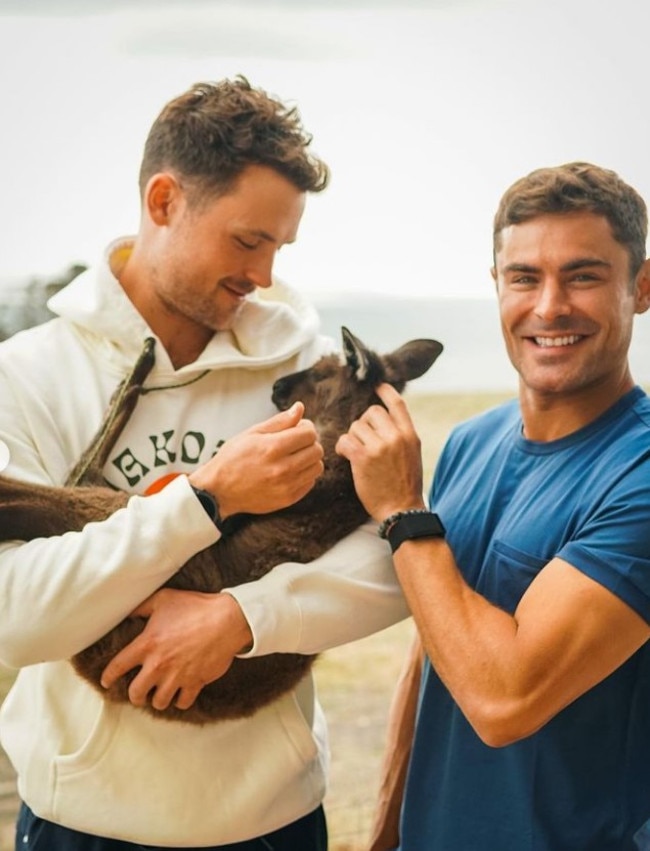 Zac and brother Dylan try to outshine the cuteness of this kangaroo. Picture: zacefron/Instagram