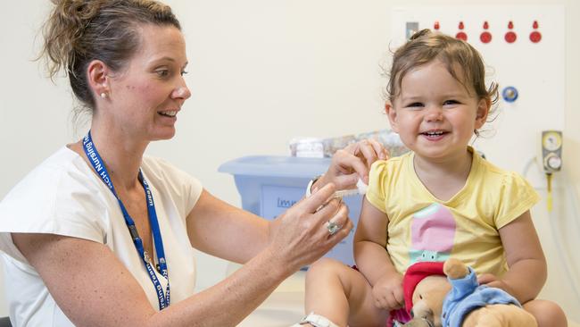 Nurse Sonja Elia gives Mackenzie, 17 months old a vaccination. (Pic: Jason Edwards)