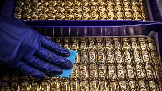 A worker polishes gold bullion bars at the ABC Refinery in Sydney. Picture: AFP