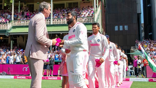 Glen McGrath collects the pink baggy cap from the Indian team. Picture Thomas Lisson