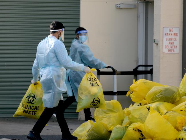 Workers pictured disposing biological waste at St Basil's Aged Care at Fawkner in 2020, when 45 residents died of COVID-19. Picture: Andrew Henshaw