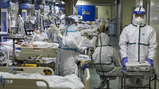 Medical workers treat patients in the isolated intensive care unit at a hospital in Wuhan in central China’s Hubei province. Picture: AP