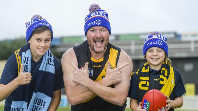 Andrew ‘Cosi’ Costello with primary school kids Jude, 11, left, and Lani, 10, right at Glenelg Oval. Picture: Roy VanDerVegt