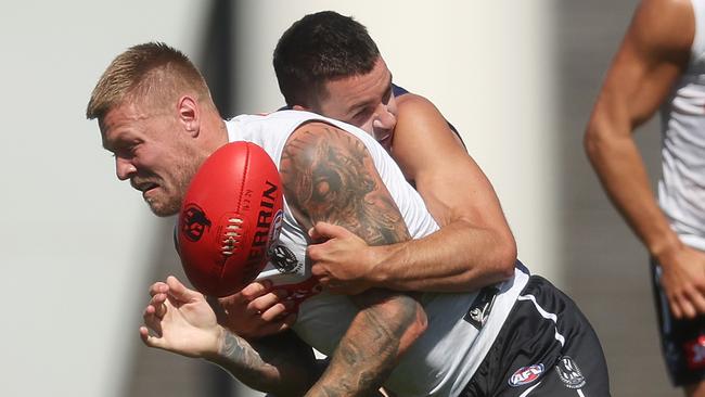 MELBOURNE, AUSTRALIA - FEBRUARY 21: Jordan De Goey of the Magpies is tackled by Luke Davies-Uniacke of the Kangaroos during an AFL practice match between North Melbourne Kangaroos and Collingwood Magpies at AIA Centre on February 21, 2024 in Melbourne, Australia. (Photo by Daniel Pockett/Getty Images)