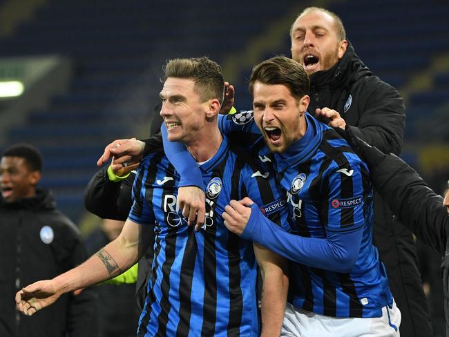 Atalanta's players celebrate a goal during the UEFA Champions League group C football match between FC Shakhtar Donetsk and Atalanta BC at the Metallist stadium in Kharkiv on December 11, 2019. (Photo by Sergei SUPINSKY / AFP)