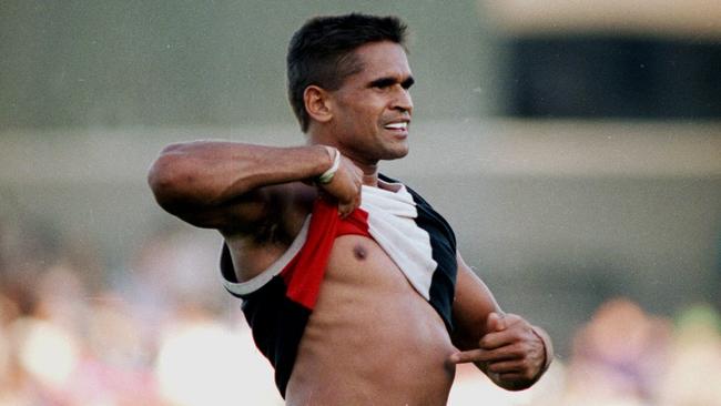 Nicky Winmar lifts his jumper and points to the colour of his skin to the Collingwood supporters at Victoria Park.