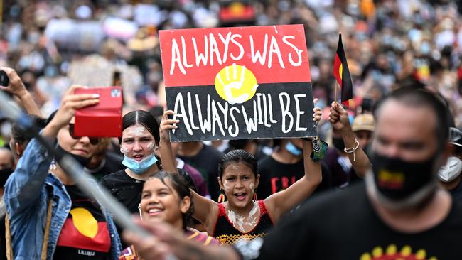 People take part in an Invasion Day protest in Brisbane on Wednesday. Picture: Dan Peled