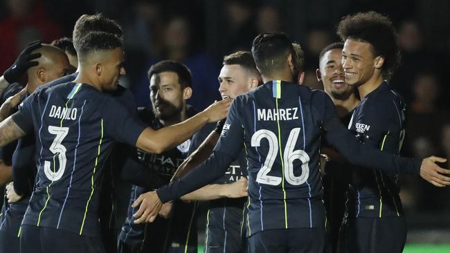 Manchester City's Leroy Sane, right, celebrates with his teammates after scoring his side's opening goal. Picture: AP