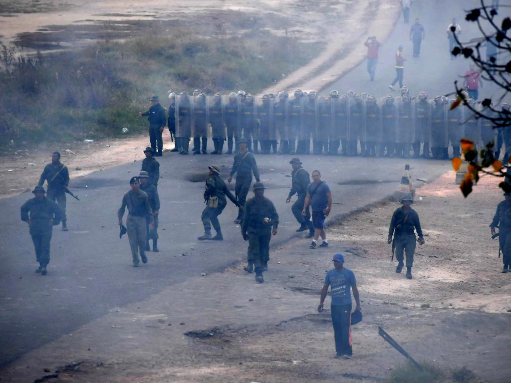 Riot police line up outside a Venezuelan police station on the border with Pacaraima, Roraima State, Brazil, where clashes erupted. Picture: AFP