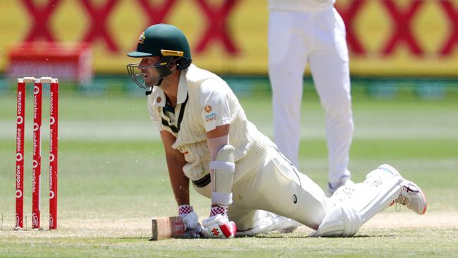 Joe Burns on his knees after surviving a run out during his eventful innings that yielded only four runs. Picture: Michael Klein