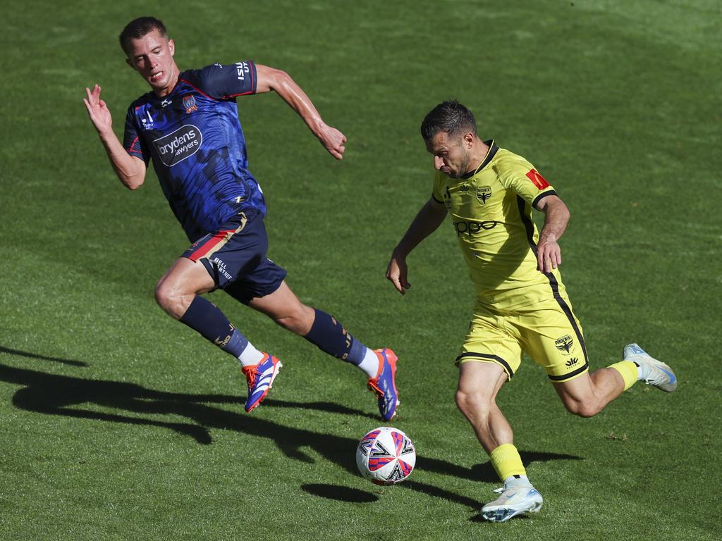 Callum Timmins of the Jets defends against Kosta Barbarouses of the Phoenix during the round 10 A-League Men match between the Wellington Phoenix and Newcastle Jets at Sky Stadium, on December 28, 2024, in Wellington, New Zealand. Picture: Hagen Hopkins/Getty Images