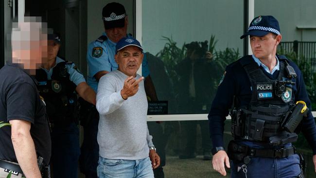 Garry Davis was marched out of his apartment on Wednesday after police were called to the property, flipping the bird to media and police. Picture: Max Mason-Hubers