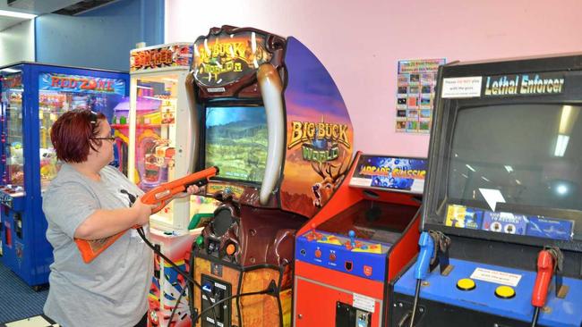 PLAY ON: Elizabeth Dennis gives the new arcade games at Video Ezy a shot. Picture: Elyse Wurm