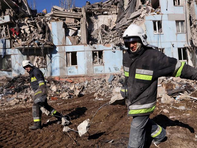 Ukrainian rescuers remove debris from the five-storey residential building destroyed after a missile strike in Zaporizhzhia. Picture: AFP