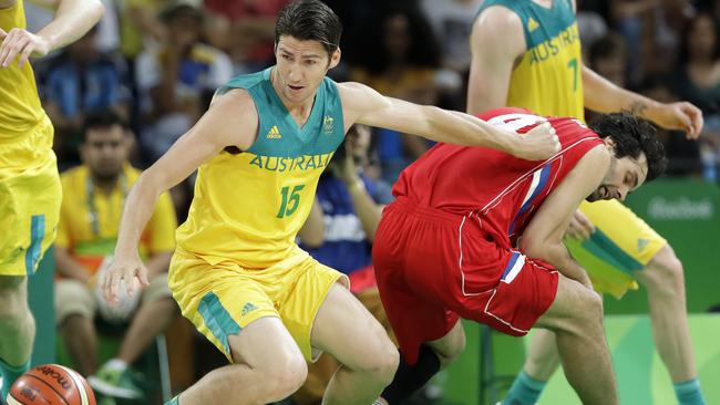 Australia's Damian Martin fights for a loose ball with Serbia's Milos Teodosic.