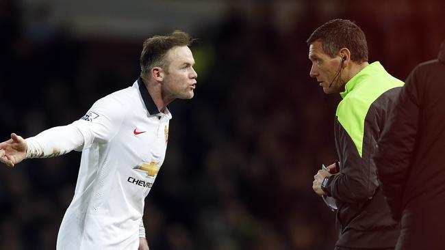 Manchester United’s Wayne Rooney, left, remonstrates with the fourth official.