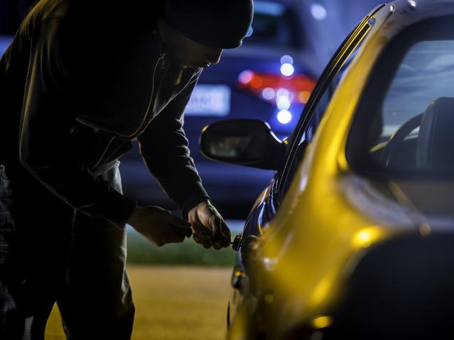 Car thief stealing a car.