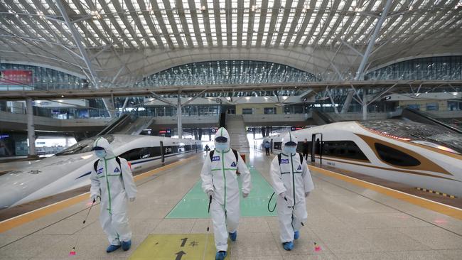 Firefighters disinfect a platform of Wuhan Railway Station in central China's Hubei province. Picture: AP