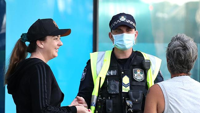 Officers speak to pedestrians as they patrol the CBD during a lockdown in Brisbane. Picture: Jono Searle