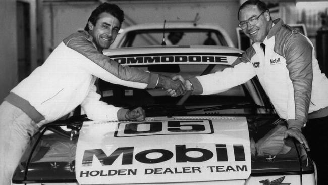 Racing driver Peter Brock shaking hands with Allan Moffat in 1986.