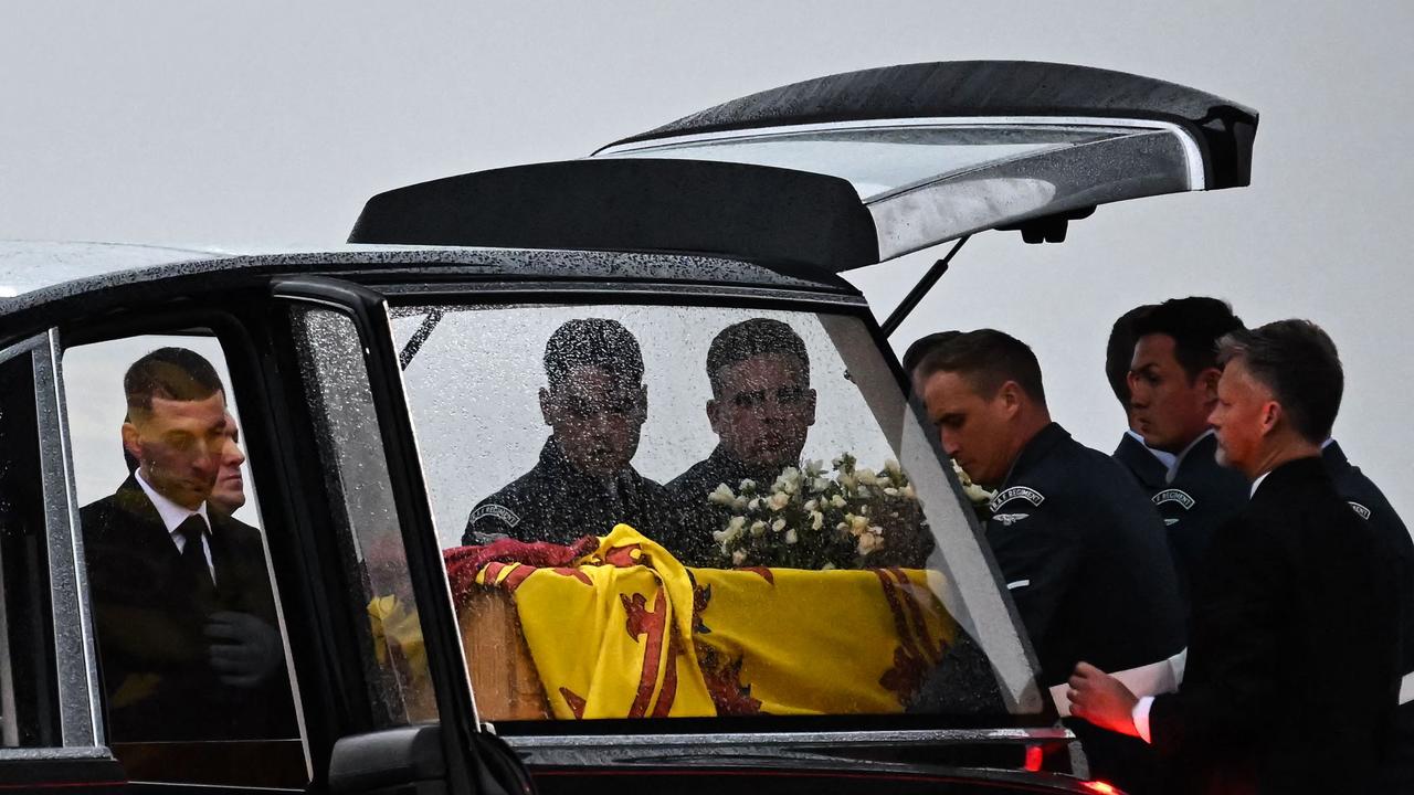 Pallbearers from the Queen's Colour Squadron (63 Squadron RAF Regiment) place the coffin of Queen Elizabeth II into the Royal Hearse. (Photo by Ben Stansall / POOL / AFP)