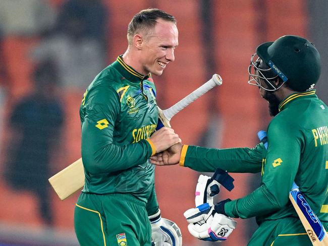 South Africa's Rassie van der Dussen and Andile Phehlukwayo (R) celebrate after winning the 2023 ICC Men's Cricket World Cup one-day international (ODI) match between South Africa and Afghanistan at the Narendra Modi Stadium in Ahmedabad on November 10, 2023. (Photo by Sajjad HUSSAIN / AFP) / -- IMAGE RESTRICTED TO EDITORIAL USE - STRICTLY NO COMMERCIAL USE --