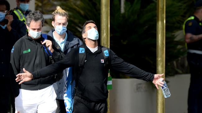 Quarantined tennis players bask in the morning sunshine as they leave their hotel for training. Picture: NCA NewsWire / Andrew Henshaw