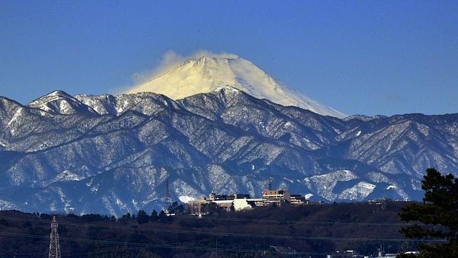 Top attraction ... snow-covered Mount Fuji is seen from Tokyo, Japan. Picture: Yoshikazu Tsuno