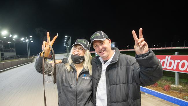 Jason Mackay with daughter April celebrate winning two major races on the finals night of the Grafton Greyhound carnival, with Zipping Maserati and the Stayers Cup with Cool Bourbski.