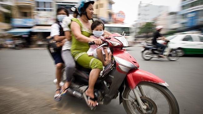 A family on the move in Ho Chi Minh City.