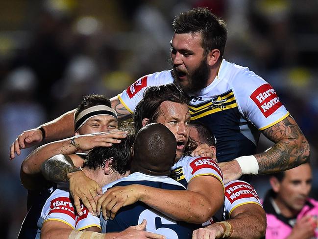 TOWNSVILLE, AUSTRALIA - SEPTEMBER 13: Robert Lui #6 of the Cowboys celebrates with team mates after scoring a try during the NRL 1st Elimination Final match between the North Queensland Cowboys and the Brisbane Broncos at 1300SMILES Stadium on September 13, 2014 in Townsville, Australia. (Photo by Ian Hitchcock/Getty Images)