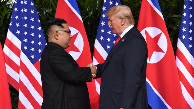 North Korea's leader Kim Jong-un shakes hands with US President Donald Trump at the start of their historic US-North Korea summit, in Singapore.