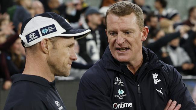 MELBOURNE, AUSTRALIAÃ June 30 , 2024.  AFL Round 16. Richmond vs Carlton at the MCG.    Michael Voss, senior coach of Carlton talks with fitness coach Andrew Russell after match   . Pic: Michael Klein