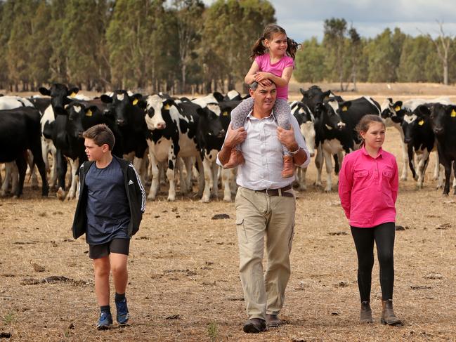 31/03/2019: Hamish Crawford with his kids Mietta (5), Hugh (9) & Amelie (10) on their dairy farm near Tatura in Victoria. Stuart McEvoy/The Australian.