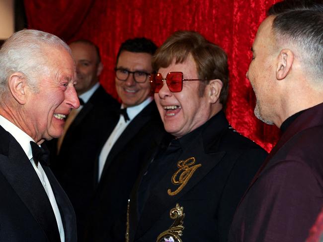 King Charles III, Elton John and his partner David Furnish (right) share a laugh. Picture: AFP