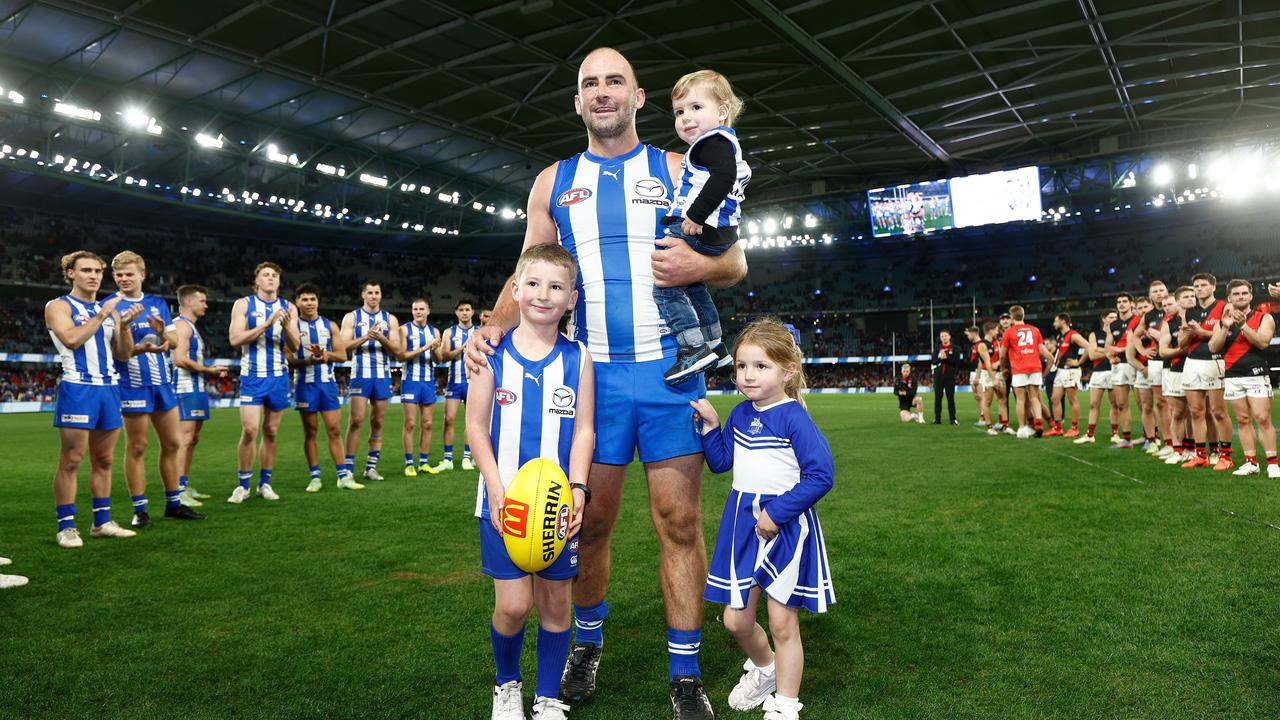 MELBOURNE, AUSTRALIA - AUGUST 12: Ben Cunnington of the Kangaroos leaves the field with children Xavier, Stella and Kobe after his final match during the 2023 AFL Round 22 match between the North Melbourne Kangaroos and the Essendon Bombers at Marvel Stadium on August 12, 2023 in Melbourne, Australia. (Photo by Michael Willson/AFL Photos via Getty Images)