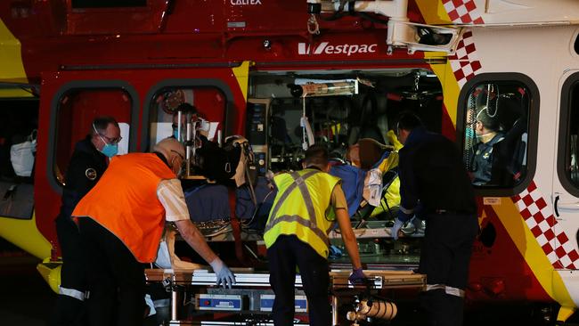 The shark attack victim arrives at John Hunter Hospital from Crescent Head. Picture: Peter Lorimer.