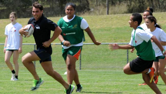 Wallabies player Nick Phipps plays against juniors from the Penrith RSL club.