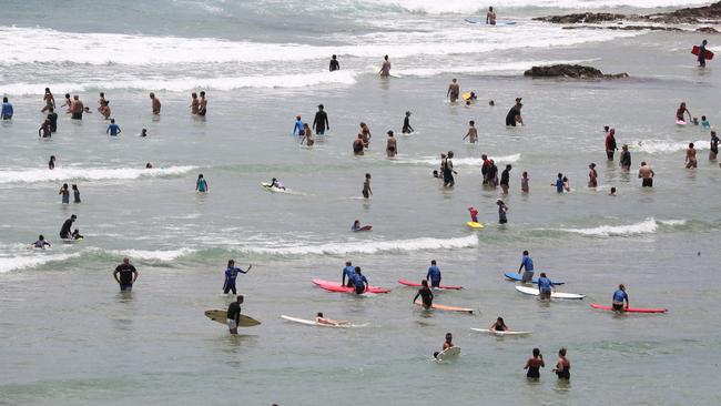 Beachgoers at Rainbow Bay on the Gold Coast. Photograph : Jason O'Brien