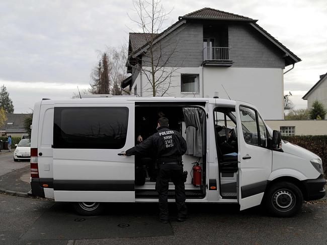 Police at a residence in Cologne. Picture: AFP