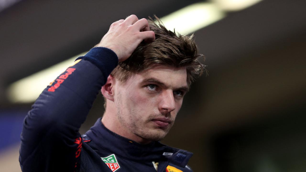 Red Bull's Dutch driver Max Verstappen reacts in the Parc Ferme of the Yas Marina Circuit after he took the pole position during the qualifying session of the Abu Dhabi Formula One Grand Prix on December 11, 2021. (Photo by KAMRAN JEBREILI / POOL / AFP)