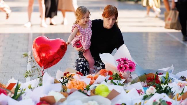 Members of the public leave floral tributes outside Westfield Bondi Junction in Sydney in the wake of Joel Cauchi’s stabbing spree last Saturday. Picture: David Swift