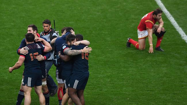 French players celebrate their victory at the end of the Six Nations match at the Stade de France.