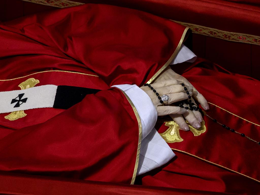 A close up of Pope Francis’s hands and the rosary beads he is clutching as he lies in state. Picture: Getty Images