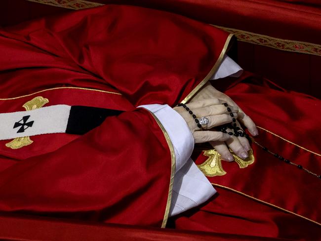 A close up of Pope Francis’s hands and the rosary beads he is clutching as he lies in state. Picture: Getty Images