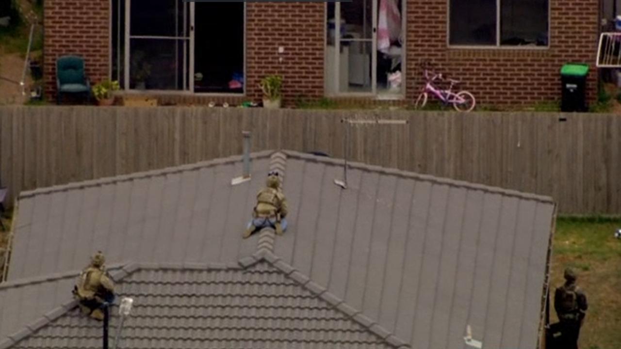 Armed personnel were on a neighbouring roof. Picture: 7News